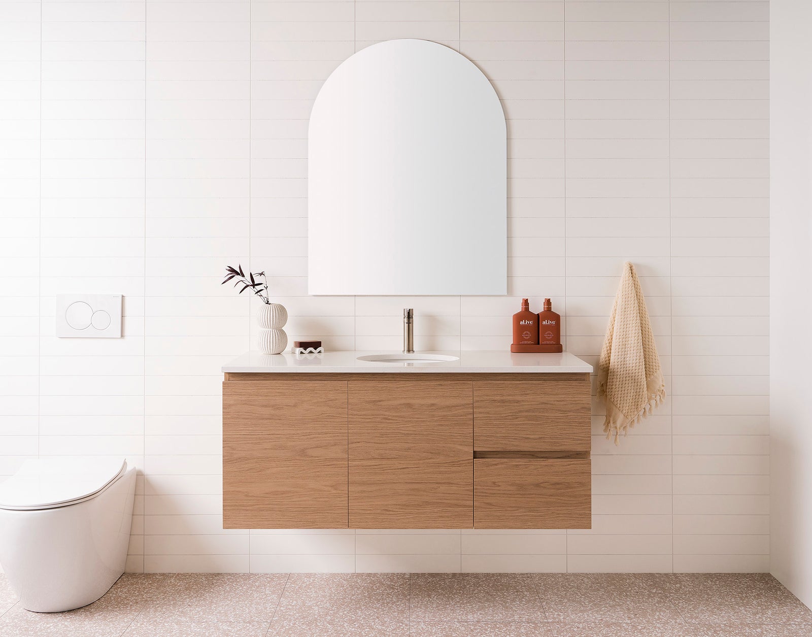 Glacier Full Depth, Door & Drawer Twin 1200 Centre Bowl. Boston Oak textured cabinet finish. 20mm Sugar Cream Cherry Pie benchtop. Oval Under-Counter Basin. 750mm Arch Mirror.