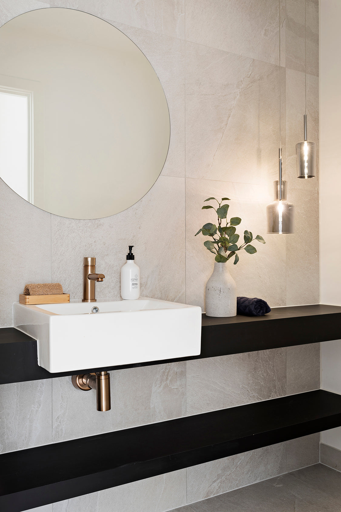 Meir Round Pinless Basin Mixer - Champagne in a bathroom