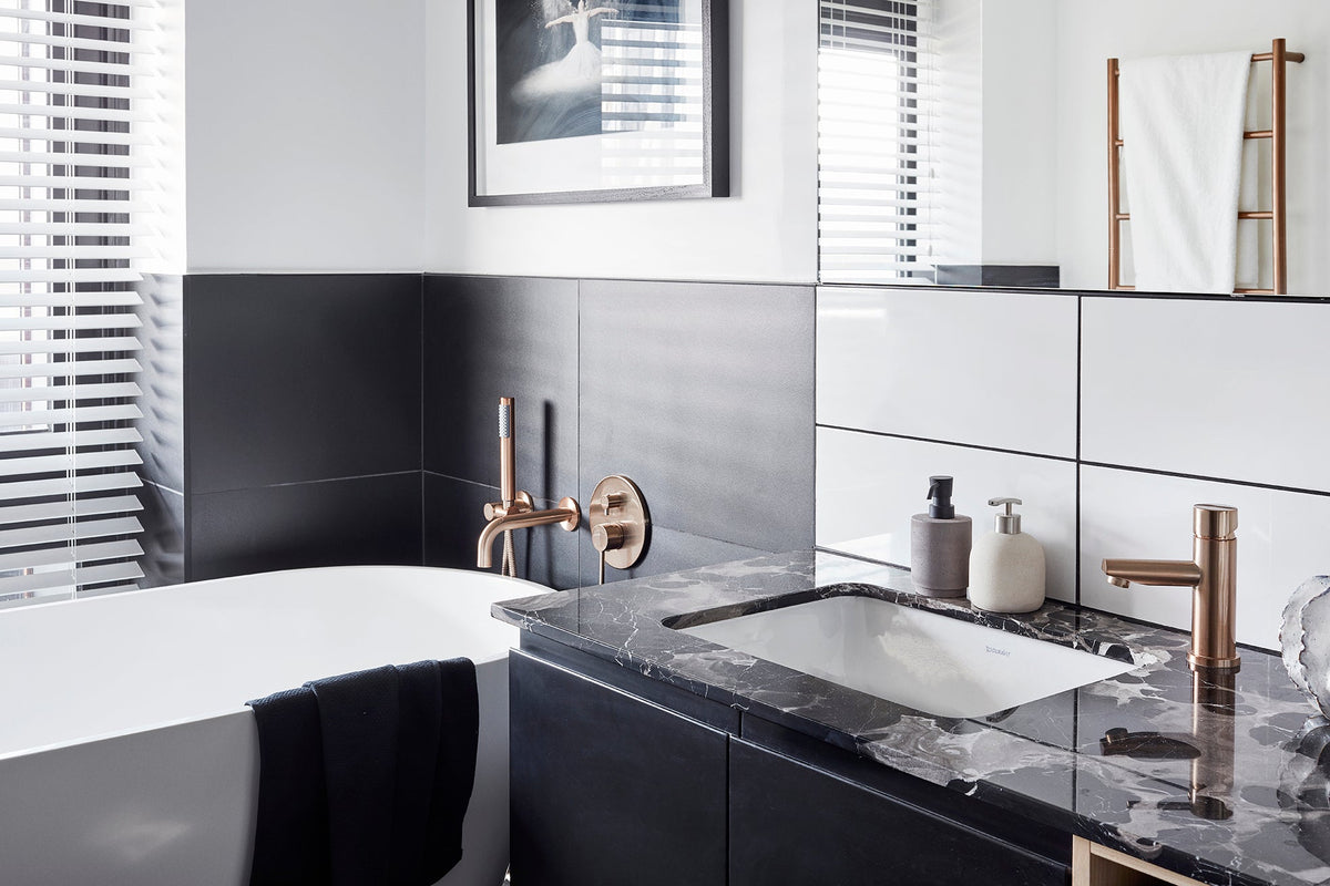 Meir Round Pinless Basin Mixer - Champagne in a bathroom
