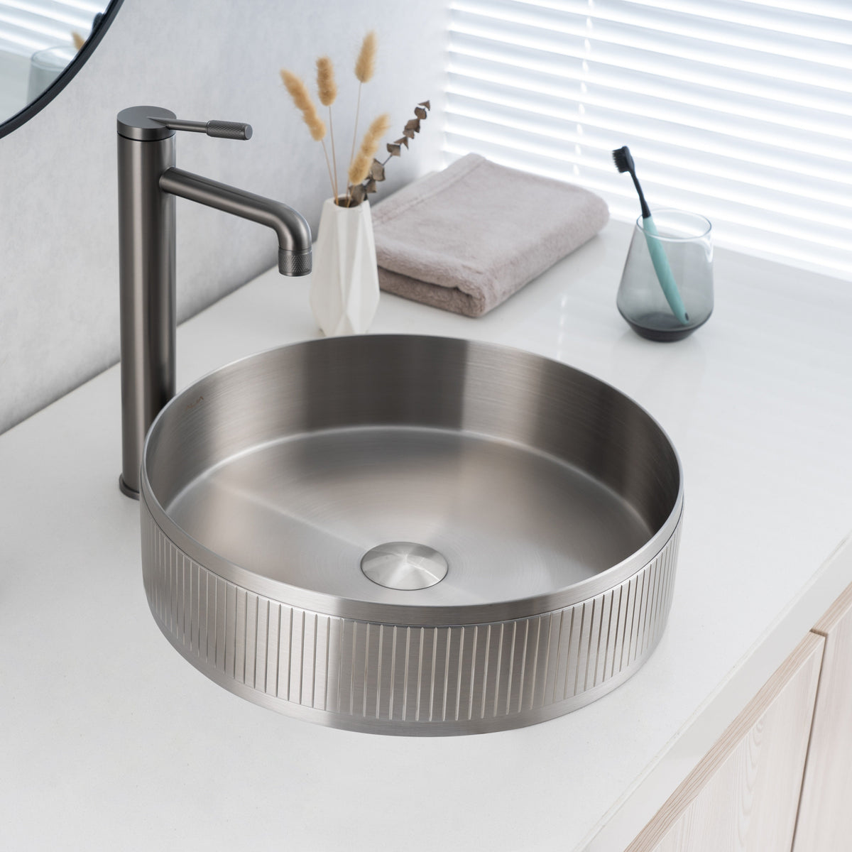 Real image of ALIA textured brushed silver round basin installed on a modern vanity, showing its subtle grain pattern and cool metallic tone.