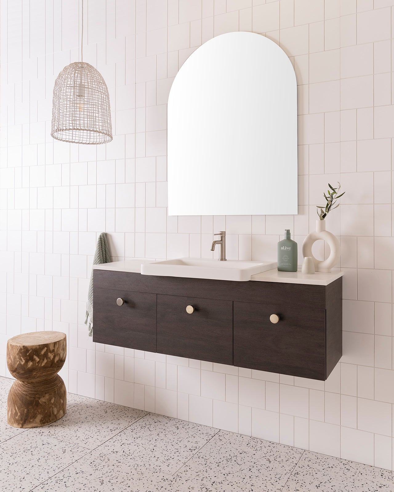 Glacier Semi-Recessed, Door & Drawer, Slim 1200 Centre Bowl. Perugian Walnut Woodmatt cabinet finish with Brushed Nickel Cooper Knobs. 20mm Frost Cherry Pie benchtop and Integrity Basin. 750mm Arch Mirror. Brushed Nickel Soul Groove basin mixer.
