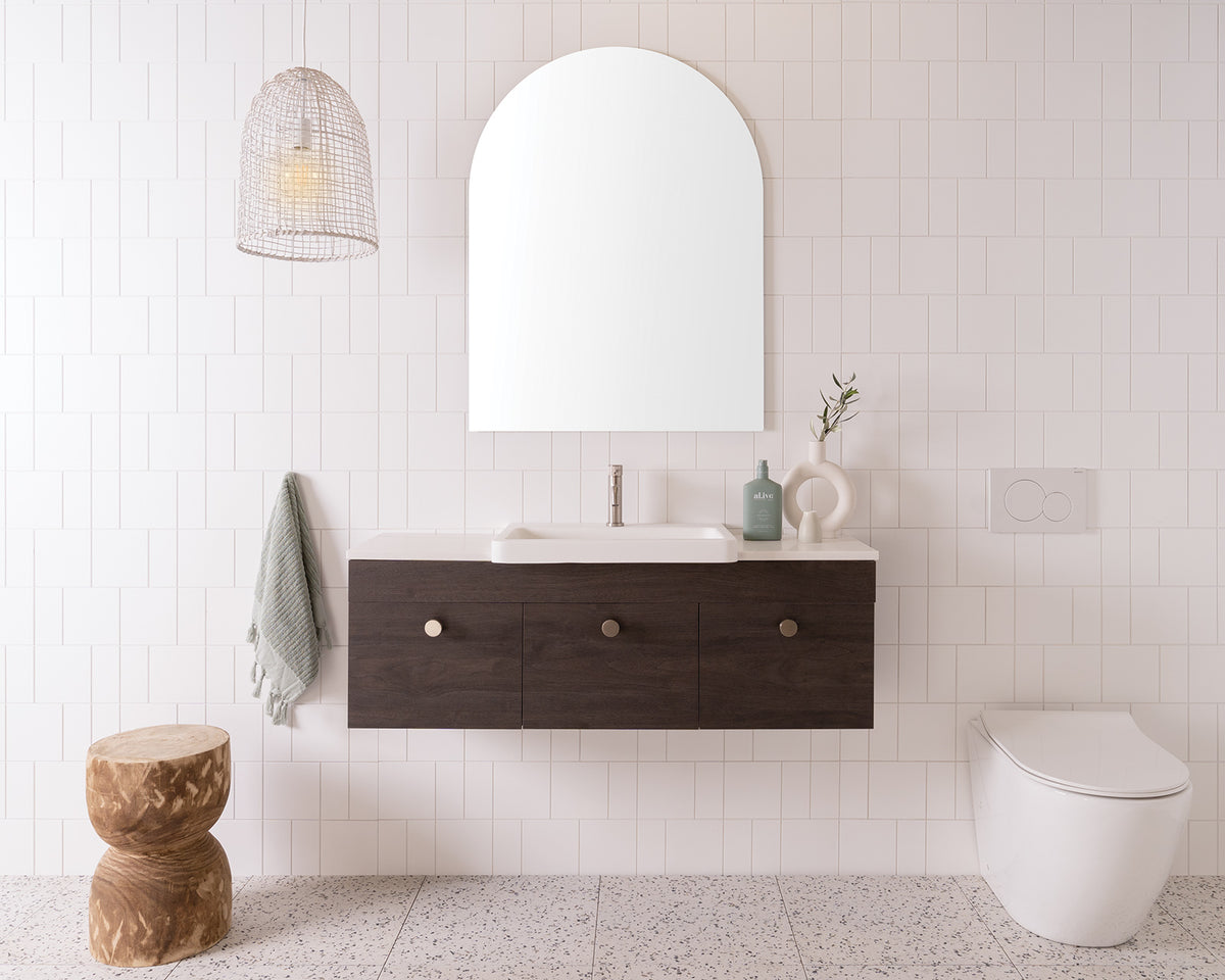 Glacier Semi-Recessed, Door & Drawer, Slim 1200 Centre Bowl. Perugian Walnut Woodmatt cabinet finish with Brushed Nickel Cooper Knobs. 20mm Frost Cherry Pie benchtop and Integrity Basin. 750mm Arch Mirror. Brushed Nickel Soul Groove basin mixer.
