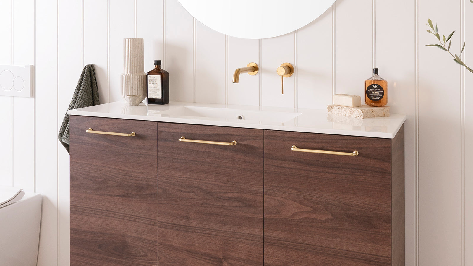 Glacier Ensuite, All-Door, Trio Floor Mount, 1200 Centre Bowl. Rojo Walnut Woodmatt cabinet finish, Cast Marble Moulded top. Brushed Brass Stirling handles. 900mm Round Mirror.