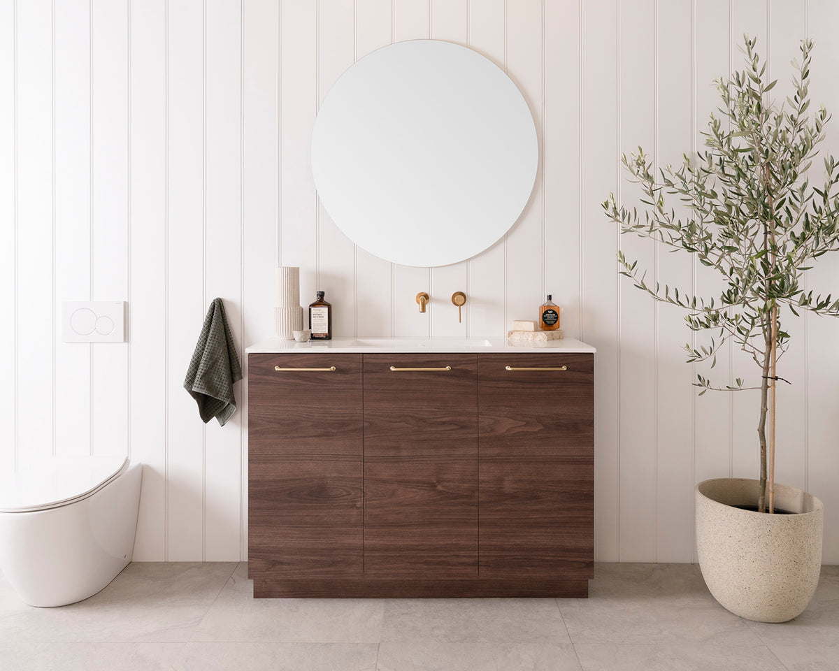 Glacier Ensuite, All-Door, Trio Floor Mount, 1200 Centre Bowl. Rojo Walnut Woodmatt cabinet finish, Cast Marble Moulded top. Brushed Brass Stirling handles. 900mm Round Mirror.