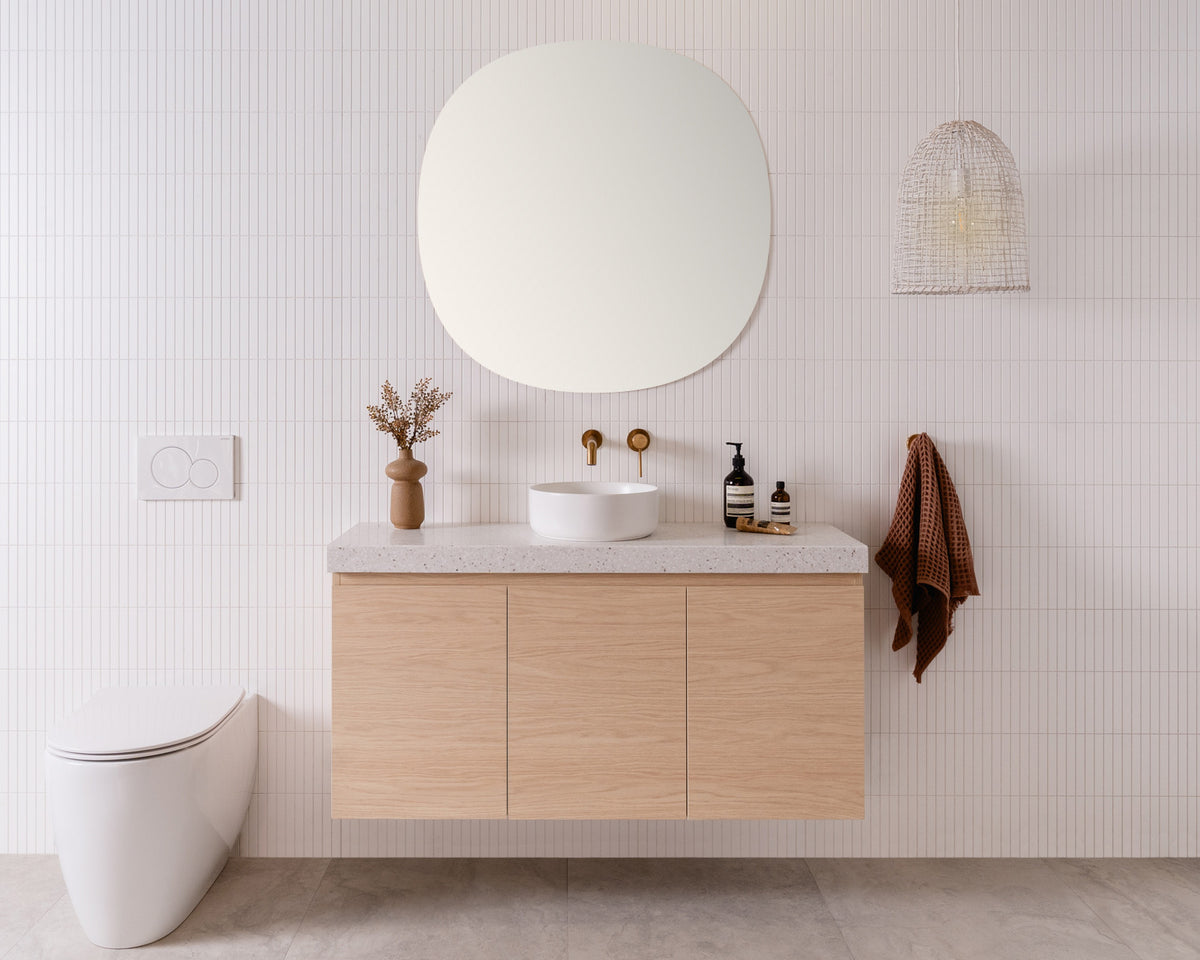 Glacier Ensuite, All-Door, Twin 1200 Centre Bowl, Blonde Oak cabinet finish, 60mm Winter Woods Durasein benchtop Orb Mirror 900x900 Maggie Above Counter basin, Matte White