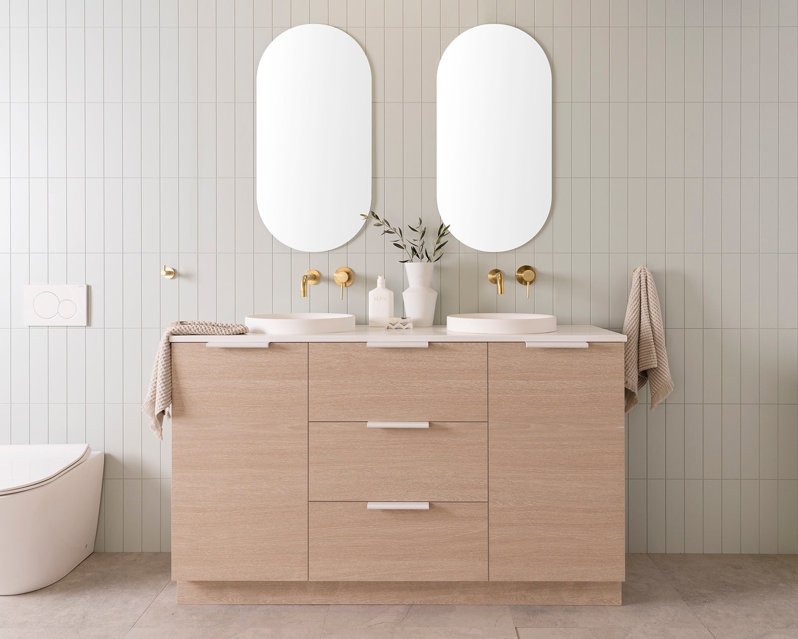 Glacier Hamper vanity, 1500 Double Bowl. Coastal Oak Woodmatt cabinet finish with Matte White Francis handles 20mm Frost Cherry Pie benchtop with Matte White Respect Semi-Inset basins. 2 x 450mm Pill Polished Edges Mirrors.