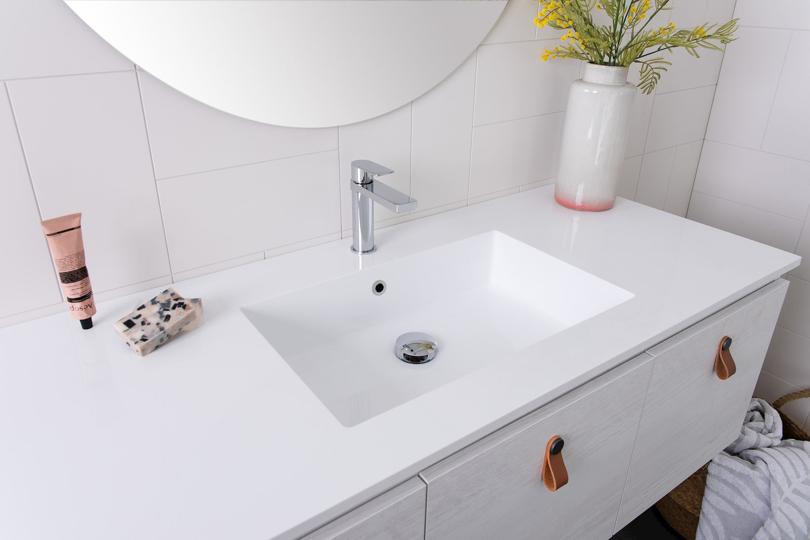 ADP Glacier vanity: Full Depth Cast Marble Moulded Top. White Painted Wood natural cabinet finish. Tan Loop Leather premium pull.